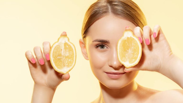 beautiful-young-woman-holding-lemon-slices