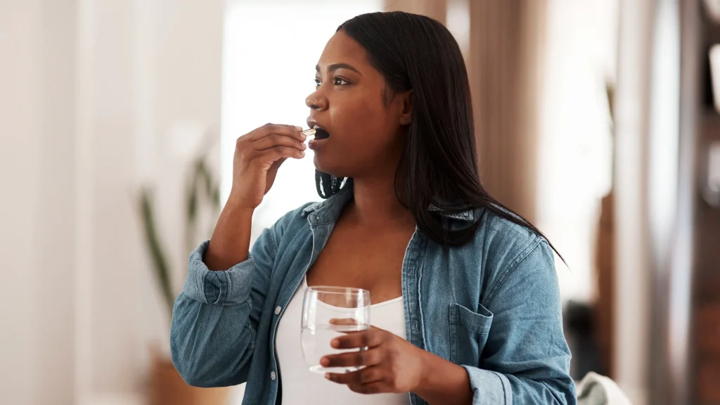 woman_taking_medication_at_home_1322388438